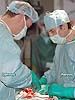 Dr Rados Djinovic, Chairman of the Sava Perovic Foundation performing surgery with Professor Perovic